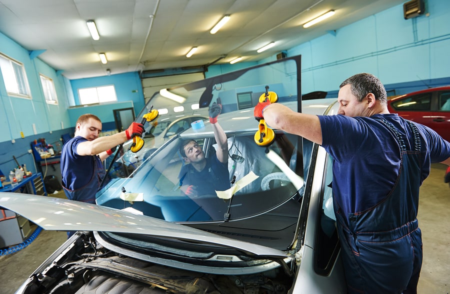 Lifting the auto glass replacement into position